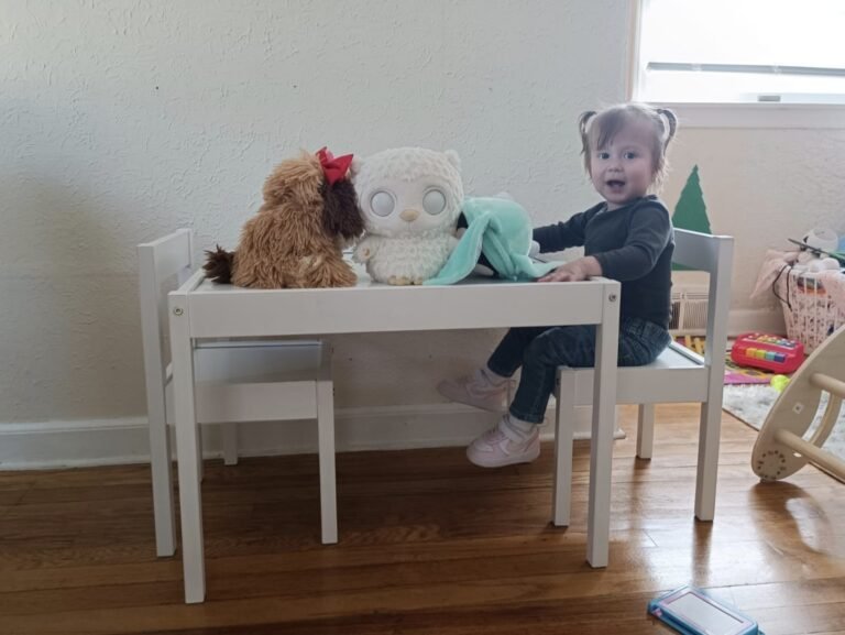 toddler with montessori table and some toys
