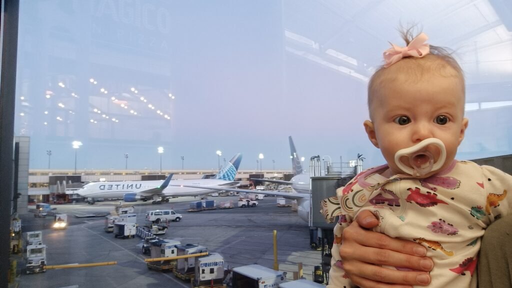 baby in front of a plane